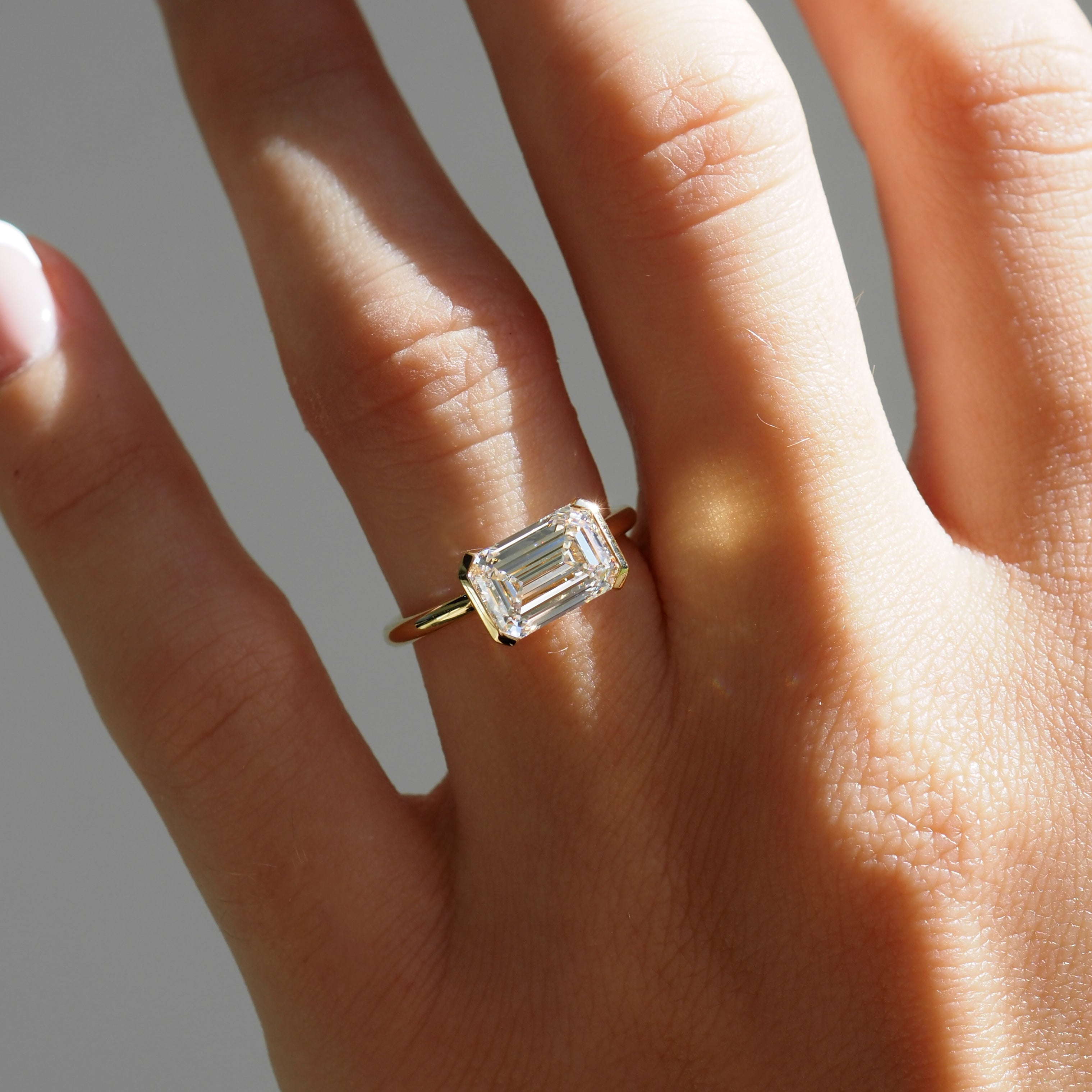 Evie | 2.5ct East West Emerald Half Bezel Solitaire Ring