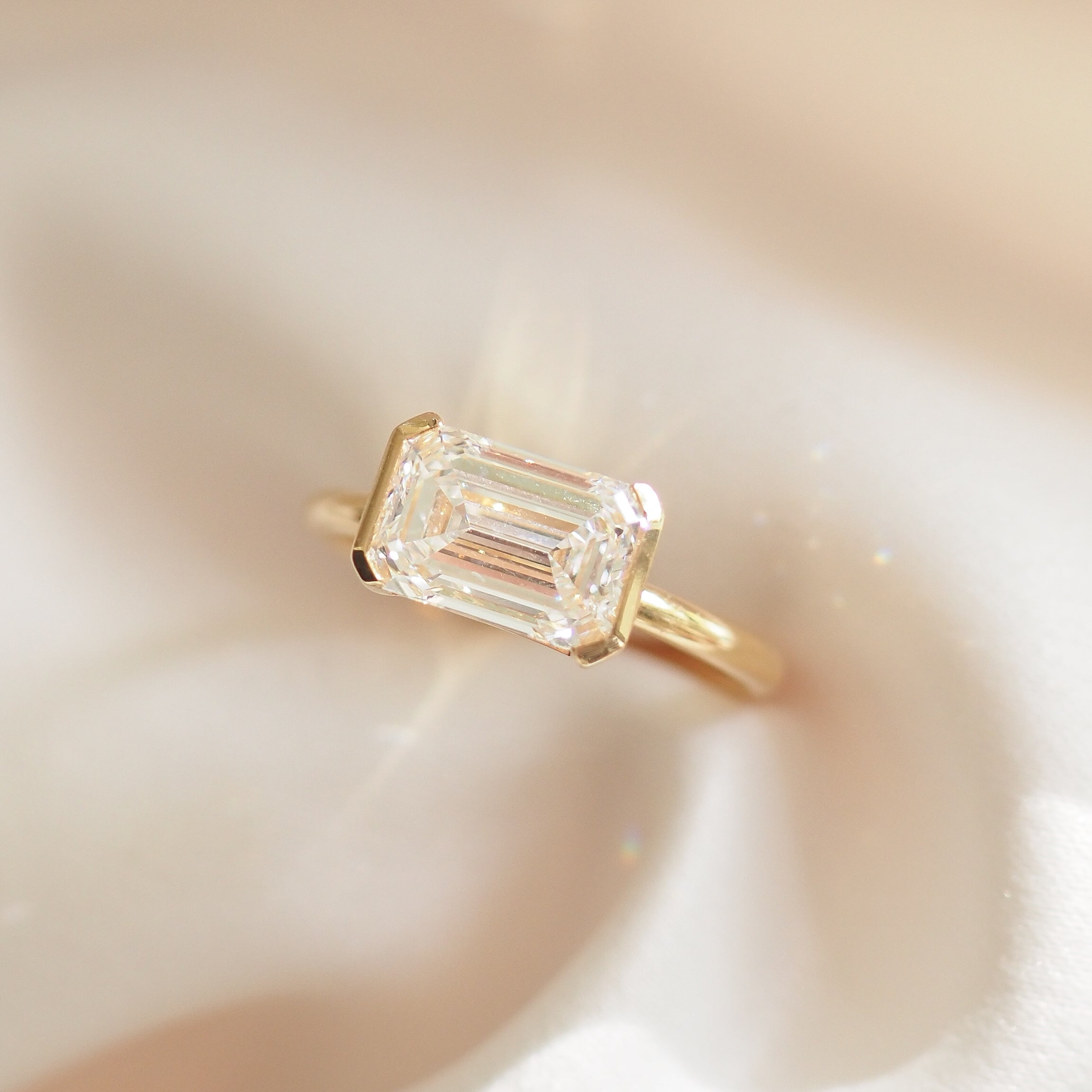Evie | 2.5ct East West Emerald Half Bezel Solitaire Ring