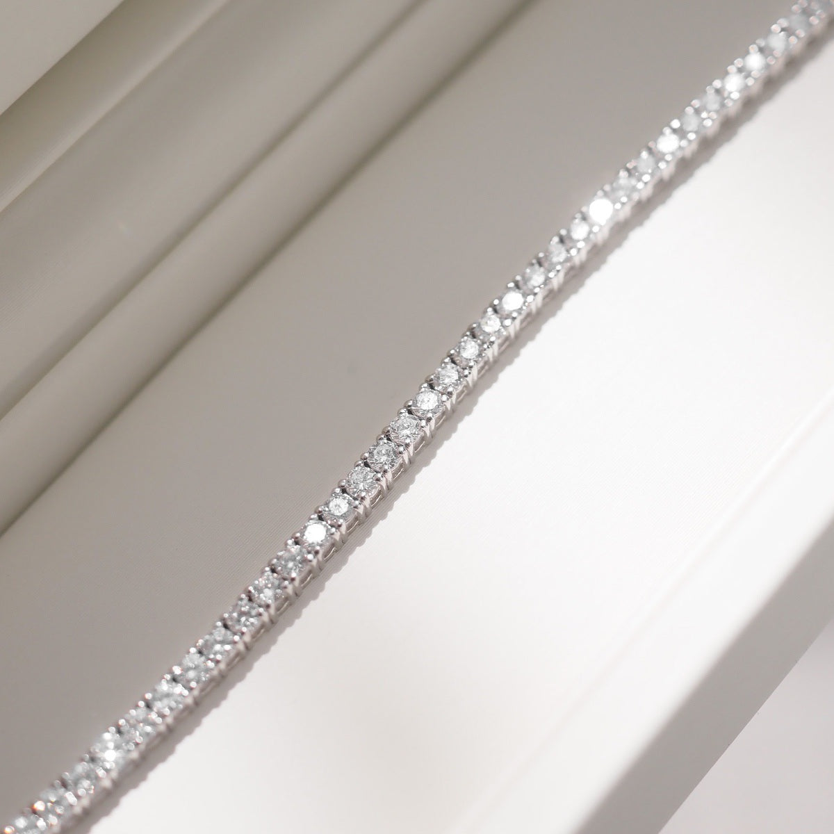 Close up of tennis bracelet on beige background