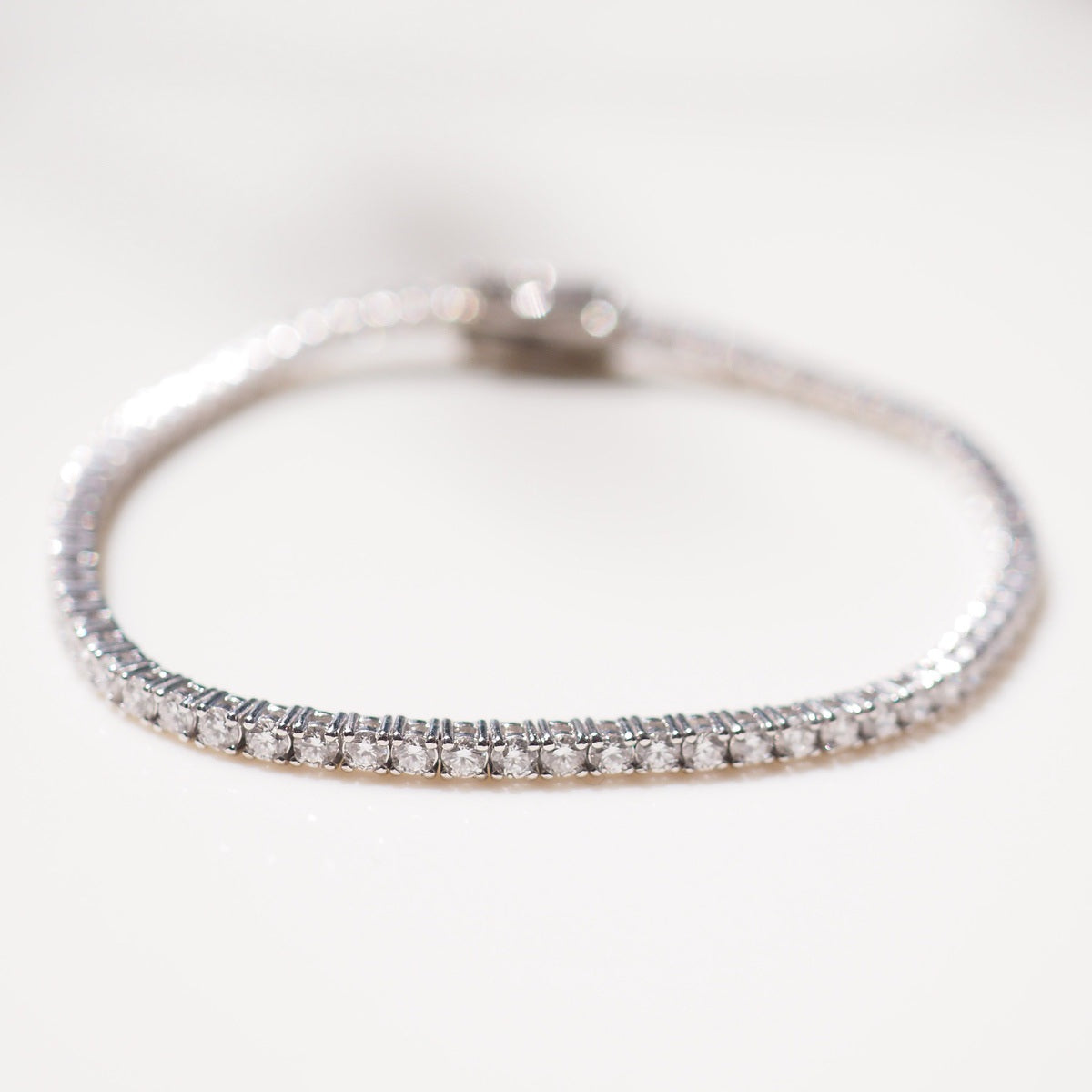 Close up of tennis bracelet on beige background