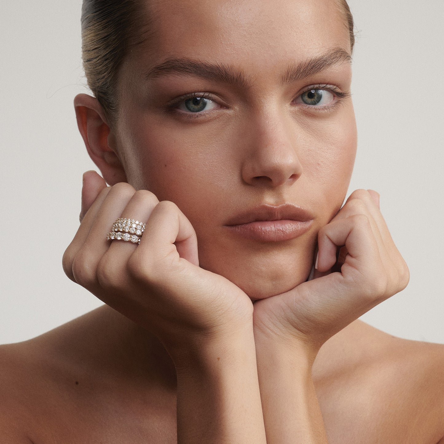 Woman with hands under chin wearing a ring on a neutral background

[text overlay: From top to bottom; 2mm, 2.5mm, 3mm and 4mm]