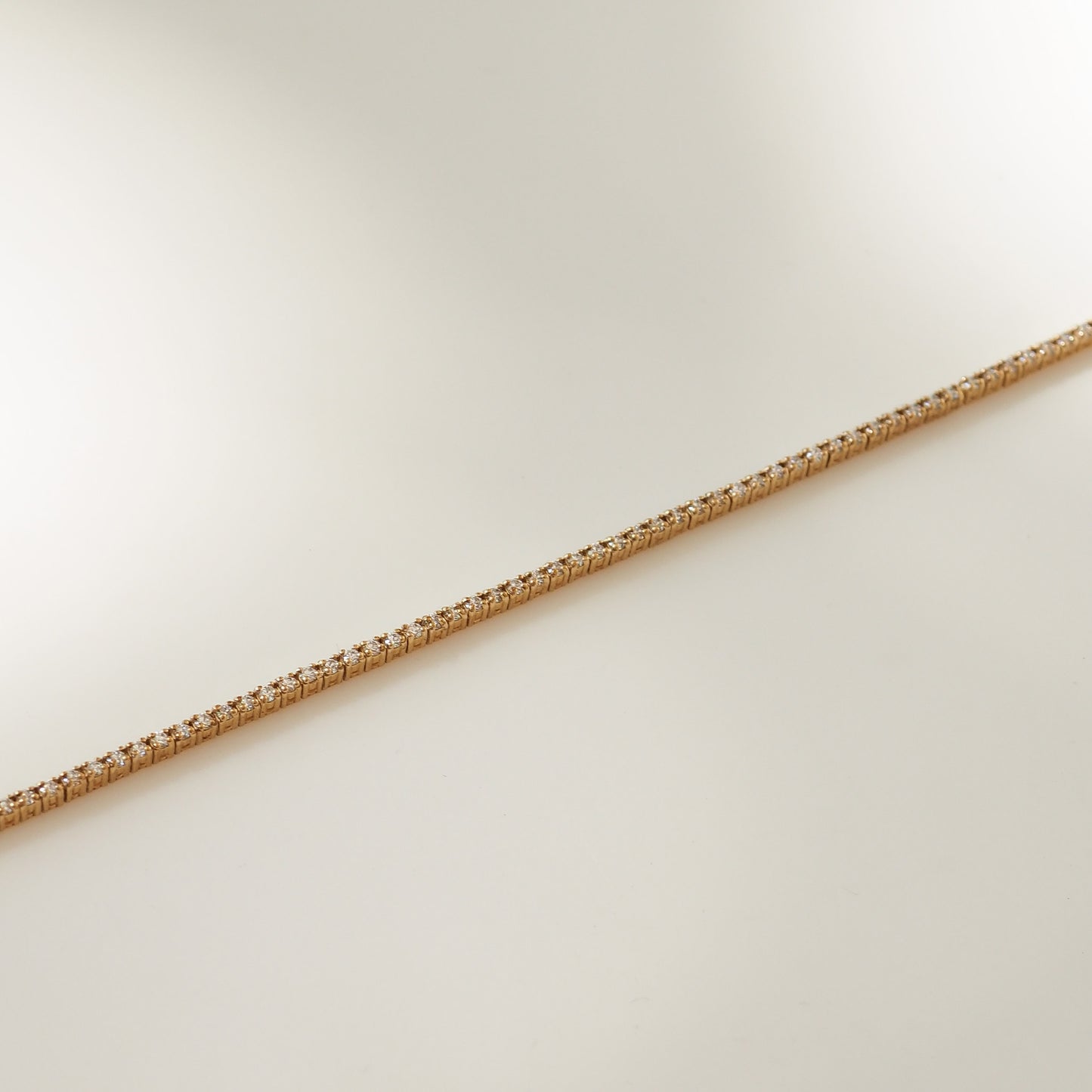 Gold chain on a light beige background