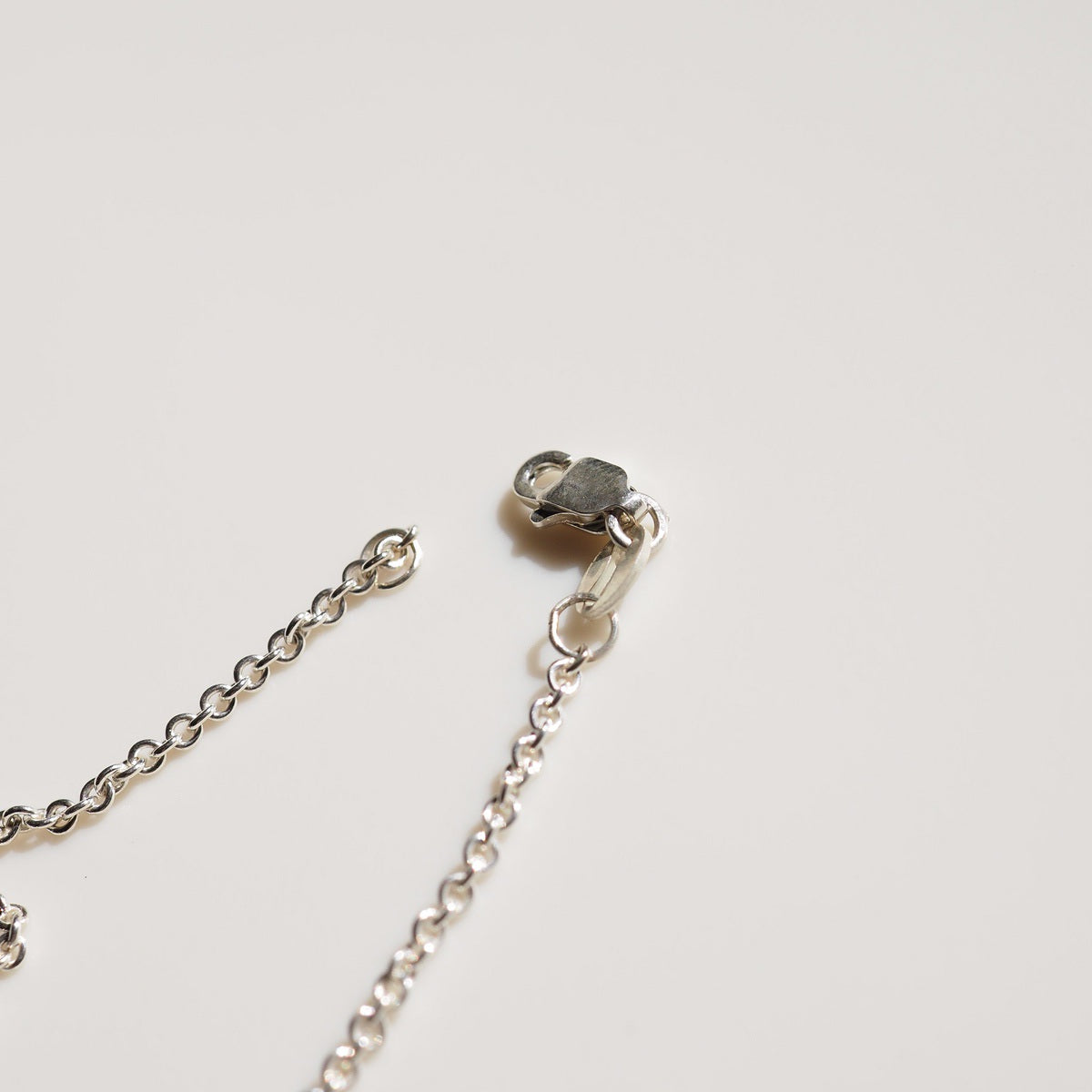 A flat lay of a clasp on a cream background