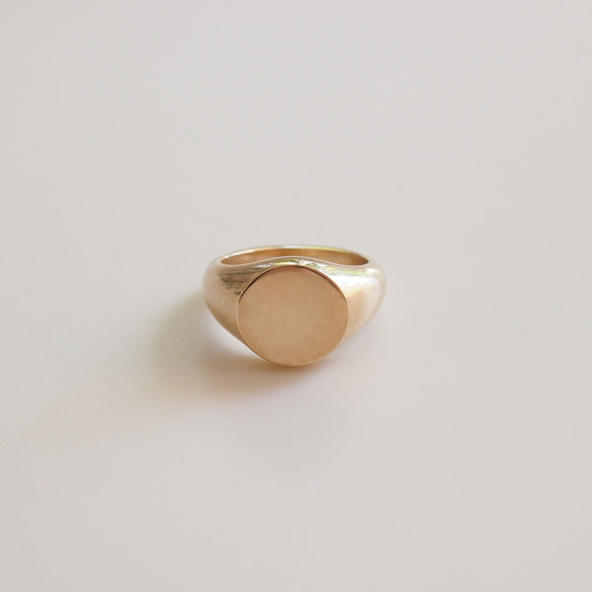Gold ring on a light gray background