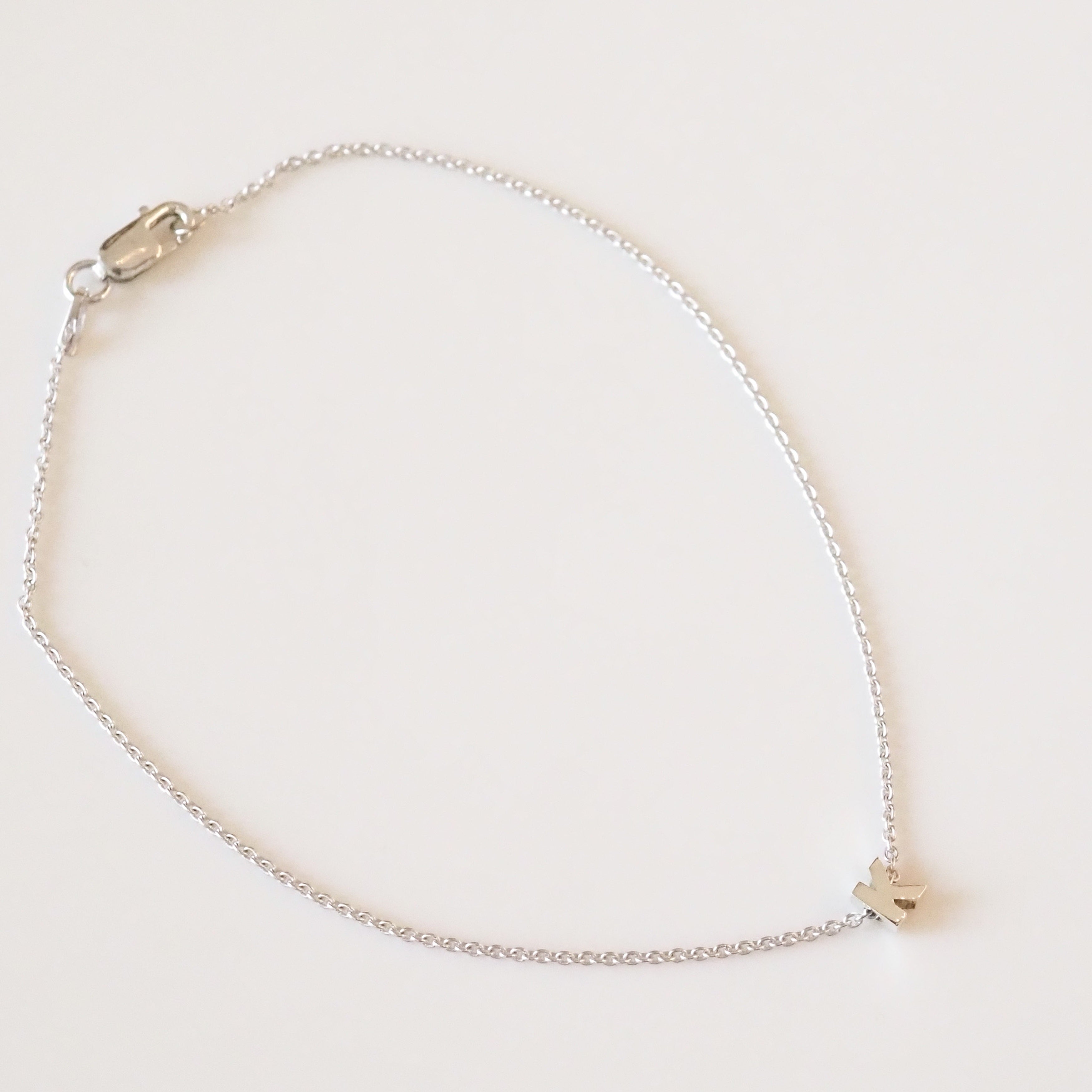 Silver bracelet on a light beige background