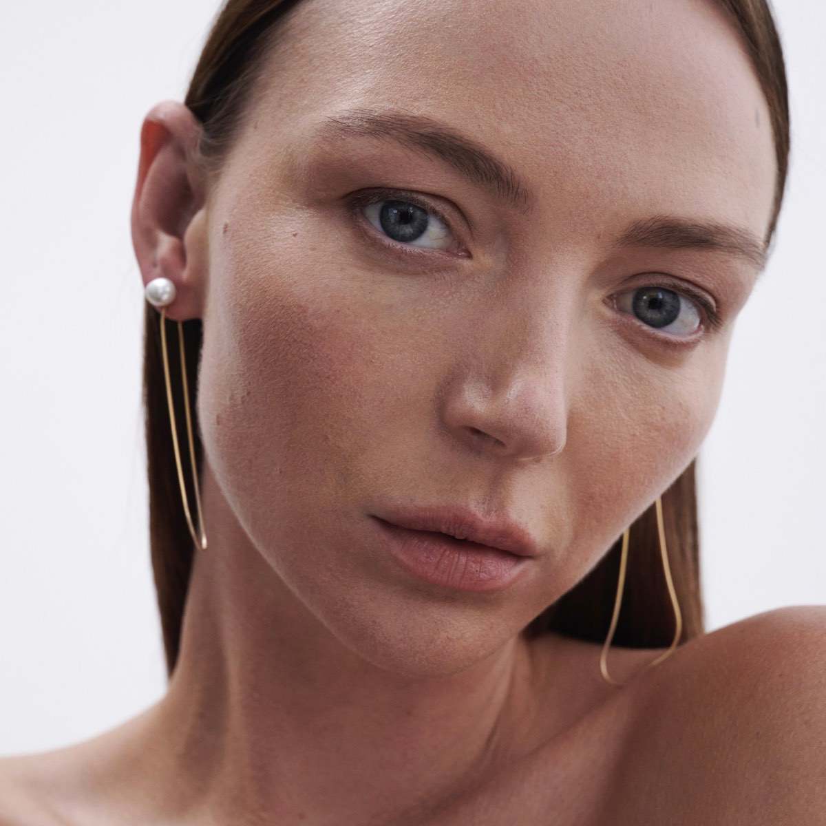 Model wears Natural Baroque Pearl Studs with Solid 9ct Yellow Gold Drops