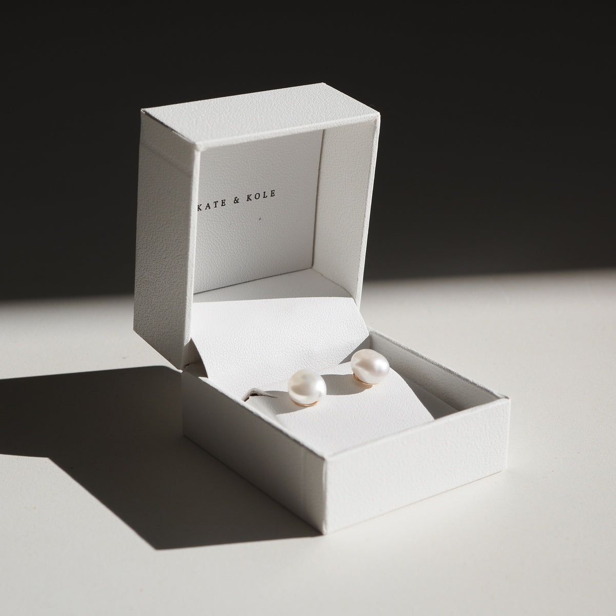 Our chic and timeless Small Baroque Pearl Studs in 9ct yellow gold sitting perfectly in a white Kate & Kole jewellery box