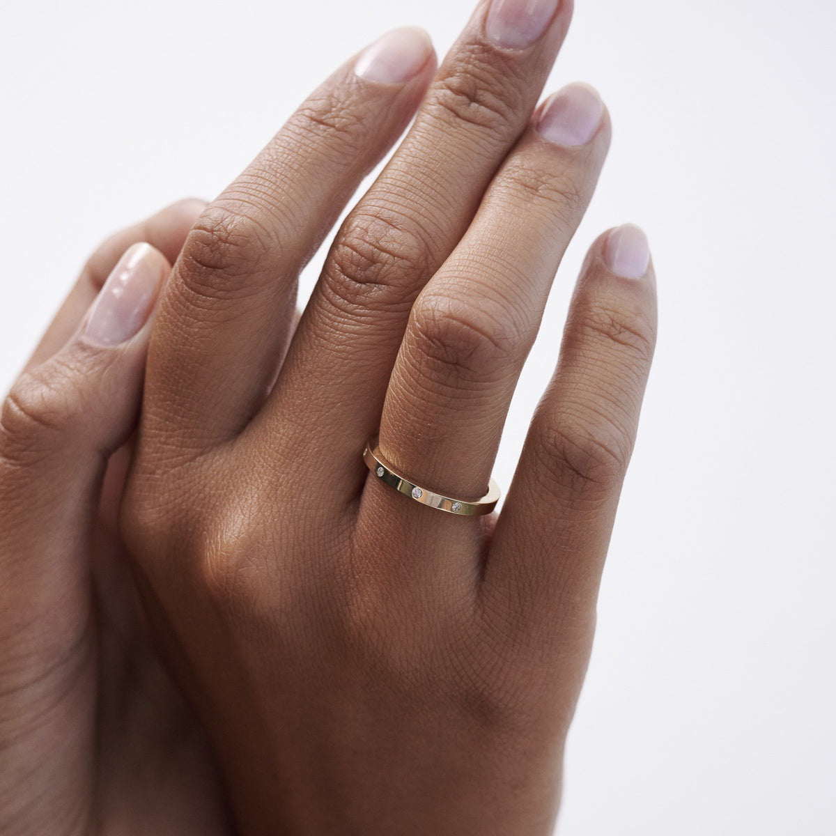 Four perfectly set flush stones on a beautifully weighted solid silver or gold band.