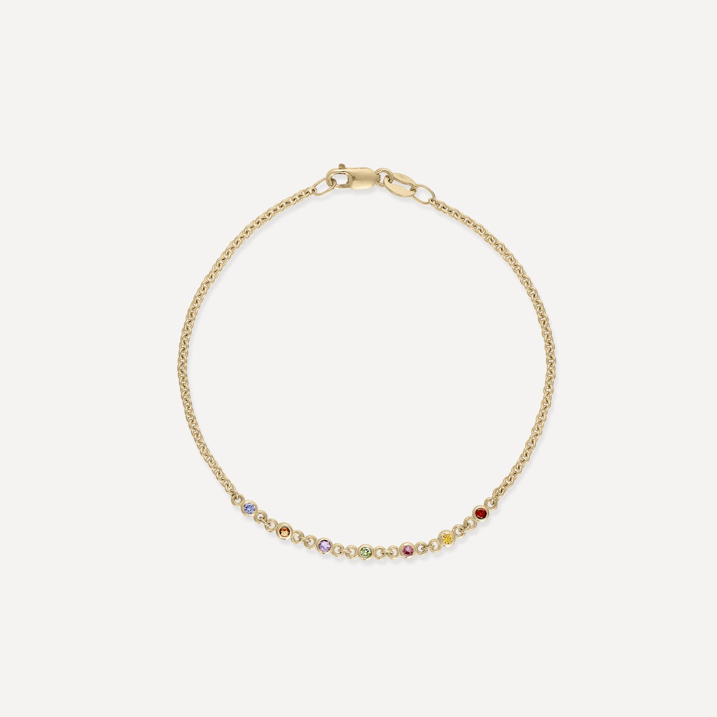 Elegant gold bracelet with a delicate chain and small multicoloured gemstones. Ideal for luxury jewellery lovers.