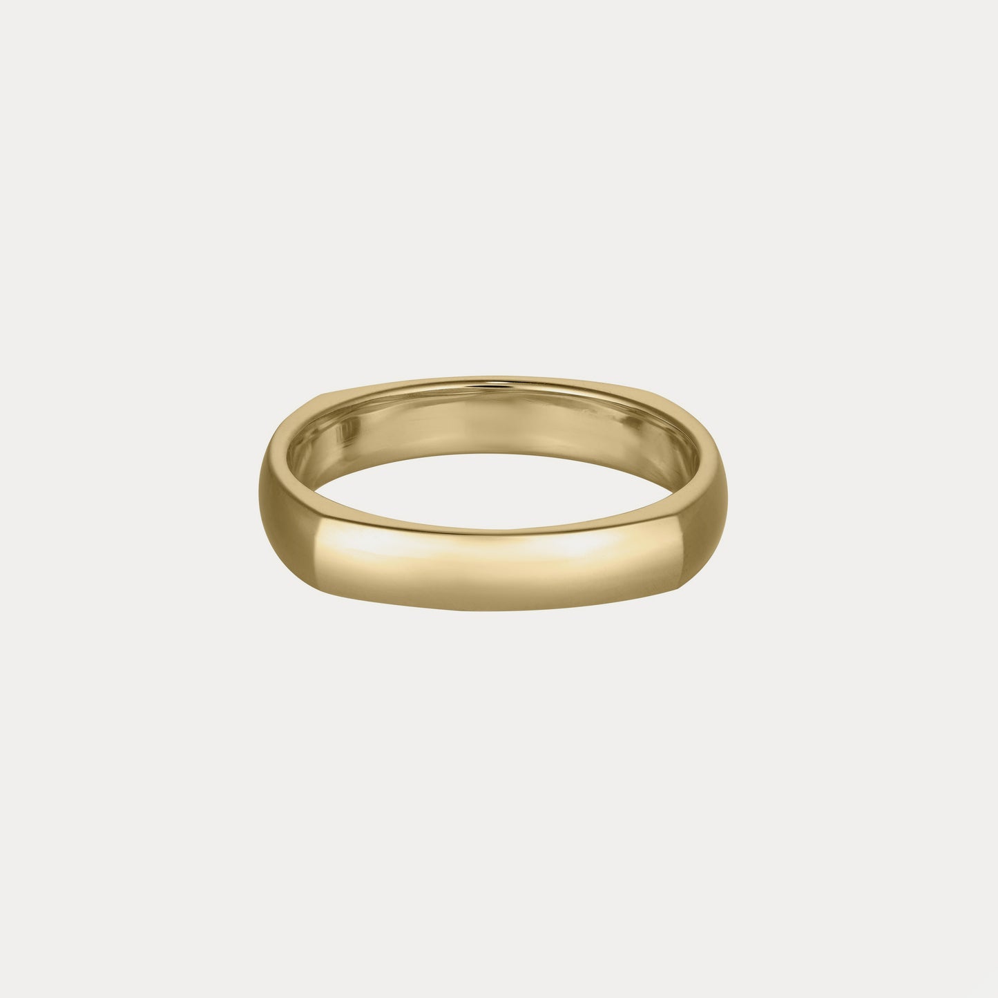 Elegant gold ring with a smooth, polished band on a neutral background, representing luxury jewellery.