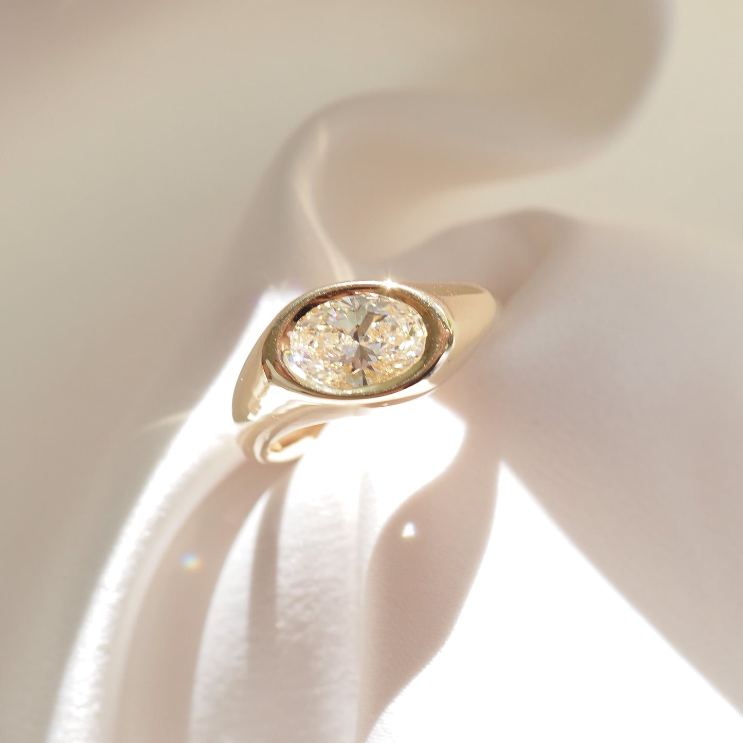 Gold ring with a diamond on a white background