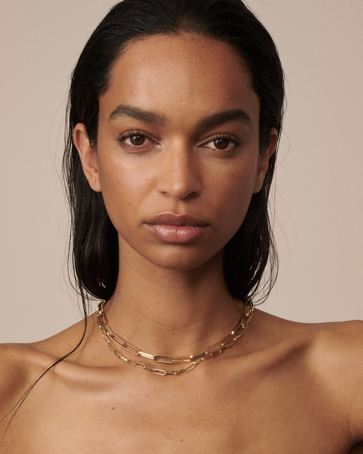Model wears 2 widths of our gold paperlink necklaces, a fine version and a bold version.