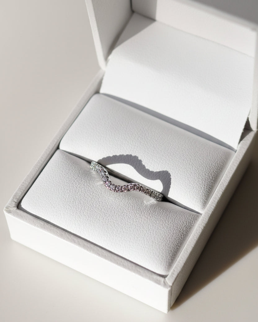 Gold ring with diamonds in a white jewelry box
