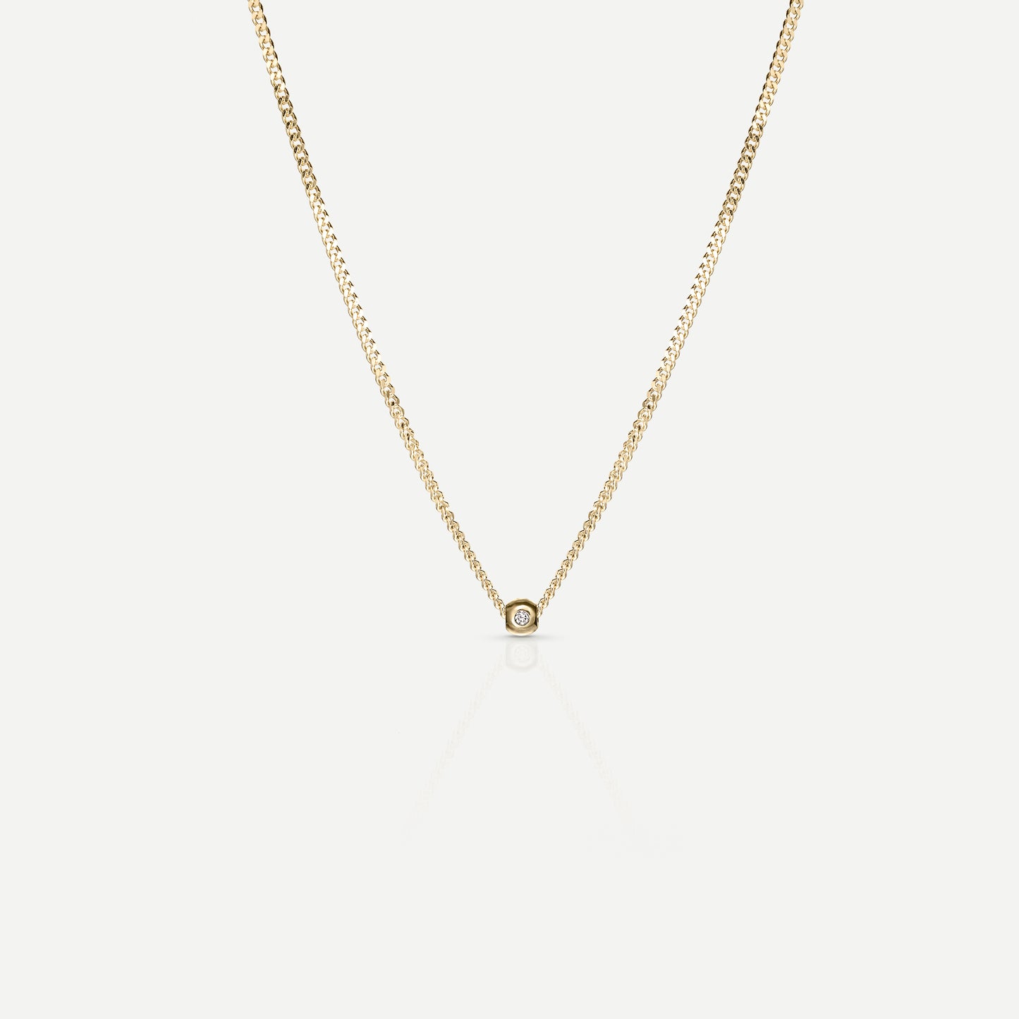 Elegant gold necklace with a delicate chain and a single, small diamond pendant, showcased on a light background. Perfect for luxury jewellery lovers.