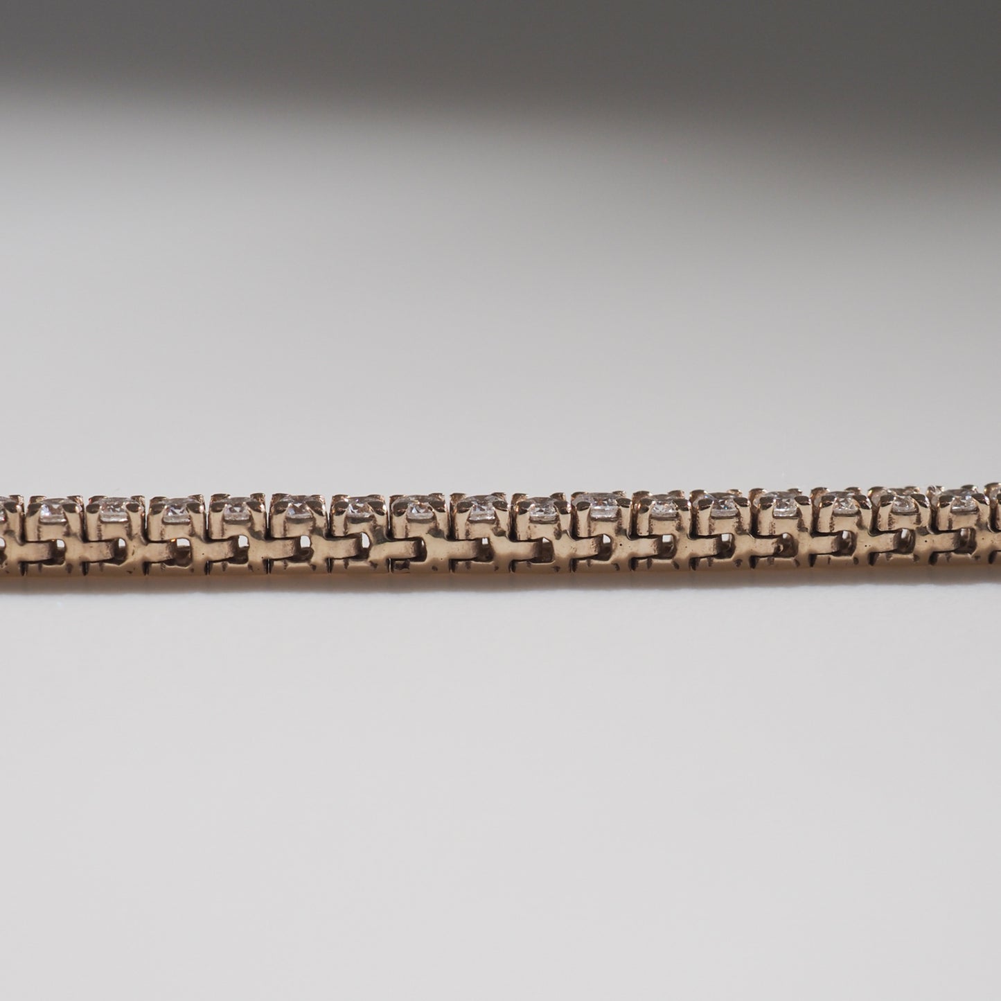 Elegant gold bracelet with intricate link design and subtle diamond accents, showcasing luxury jewellery craftsmanship.