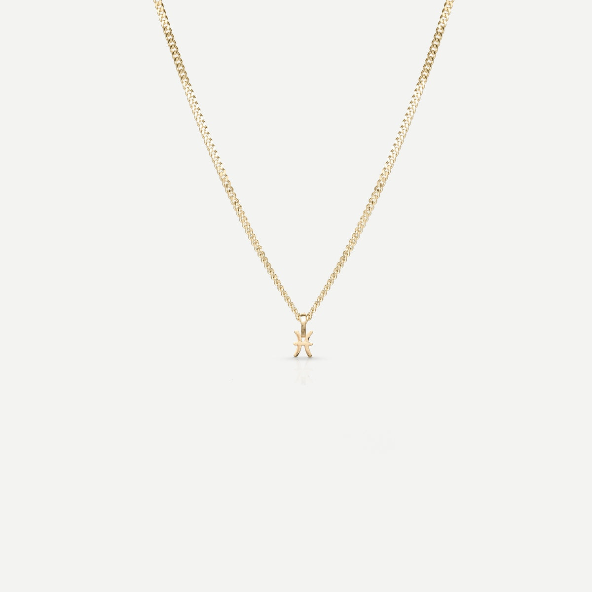 Solid gold and silver jewellery: A single Kate & Kole hand finished zodiac necklace in 9ct yellow gold. [text overlay: Pisces] [text colour: #000000]
